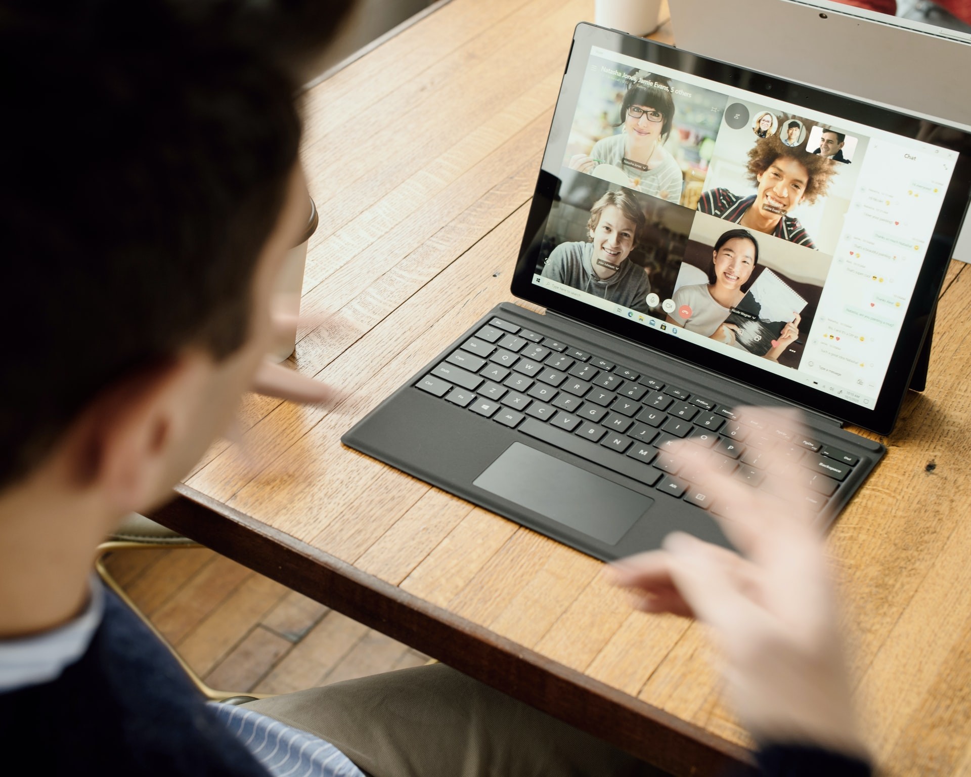 Teacher talks to students through an online learning platform video call.