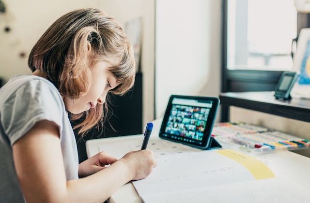 Student working on her tablet at home.