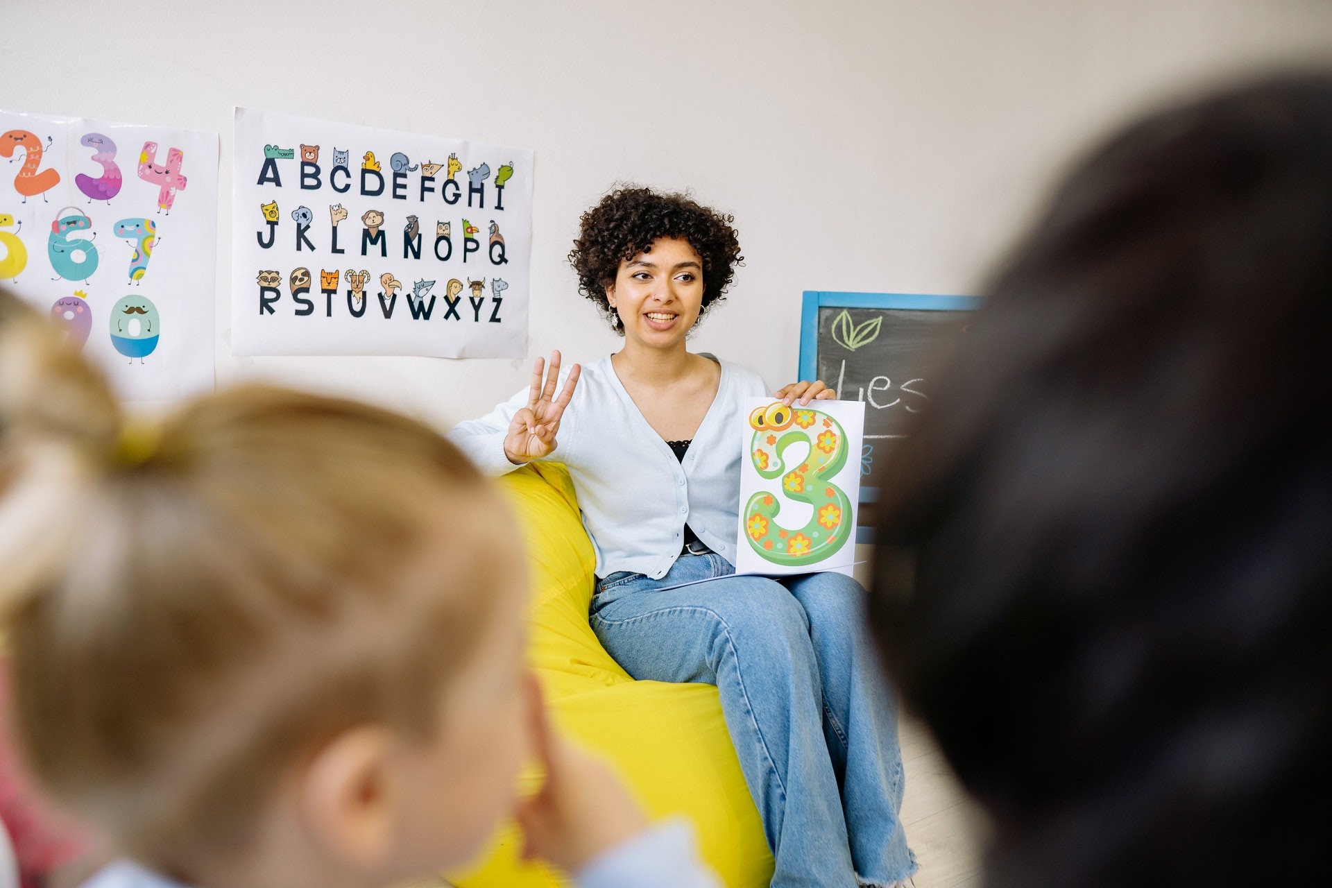 Teacher in a classroom teaches students about numbers.