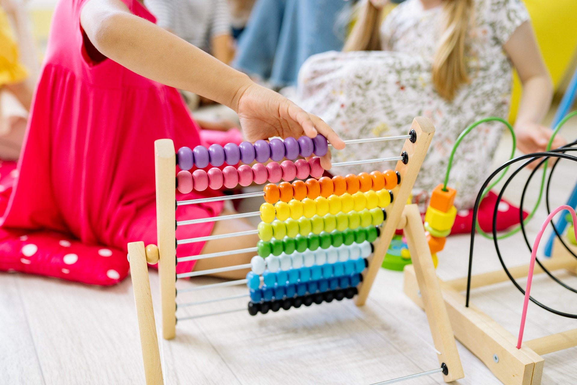 Students play with an abacus during fun math activities.