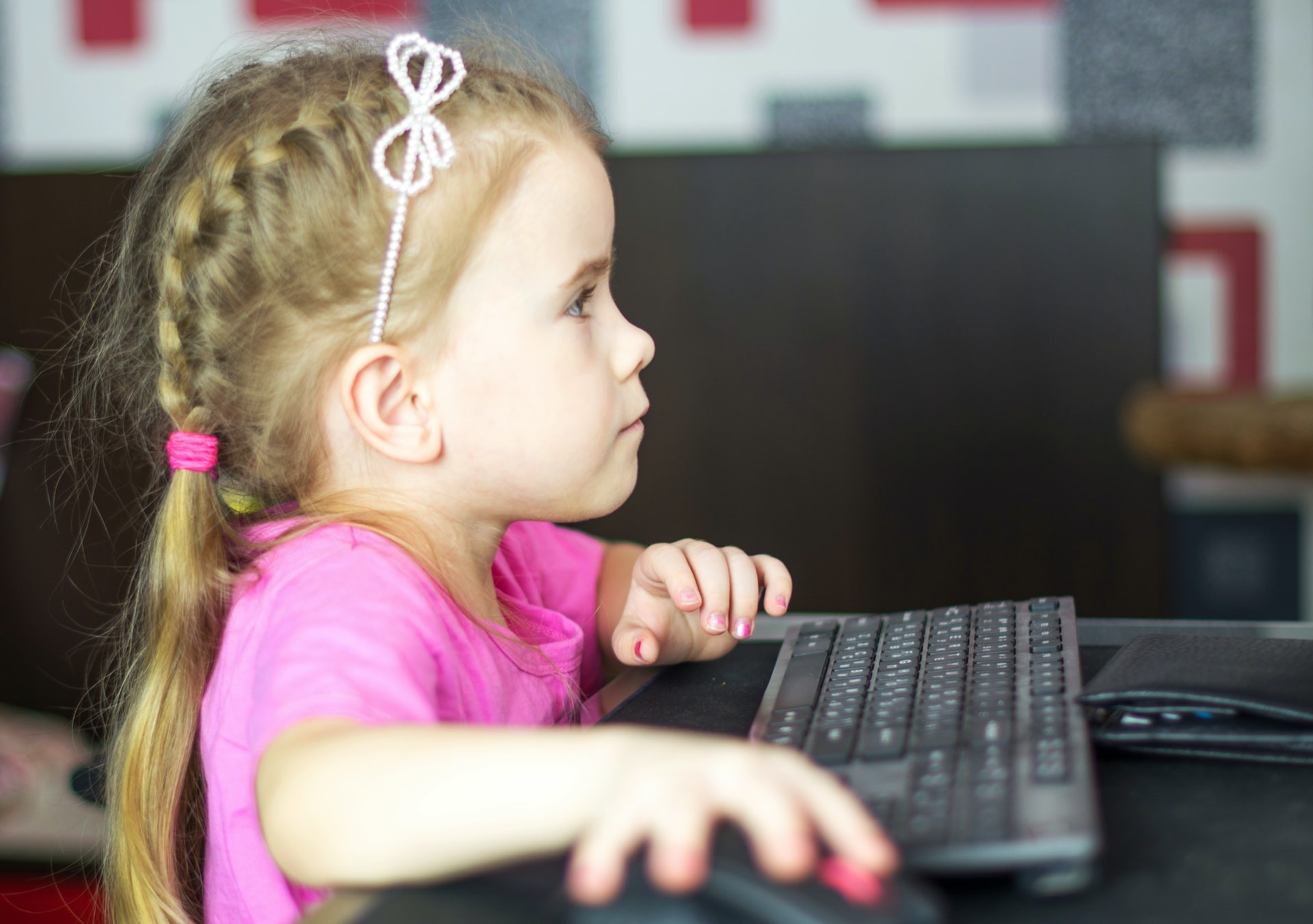 Young elementary student uses a computer for fun math activities