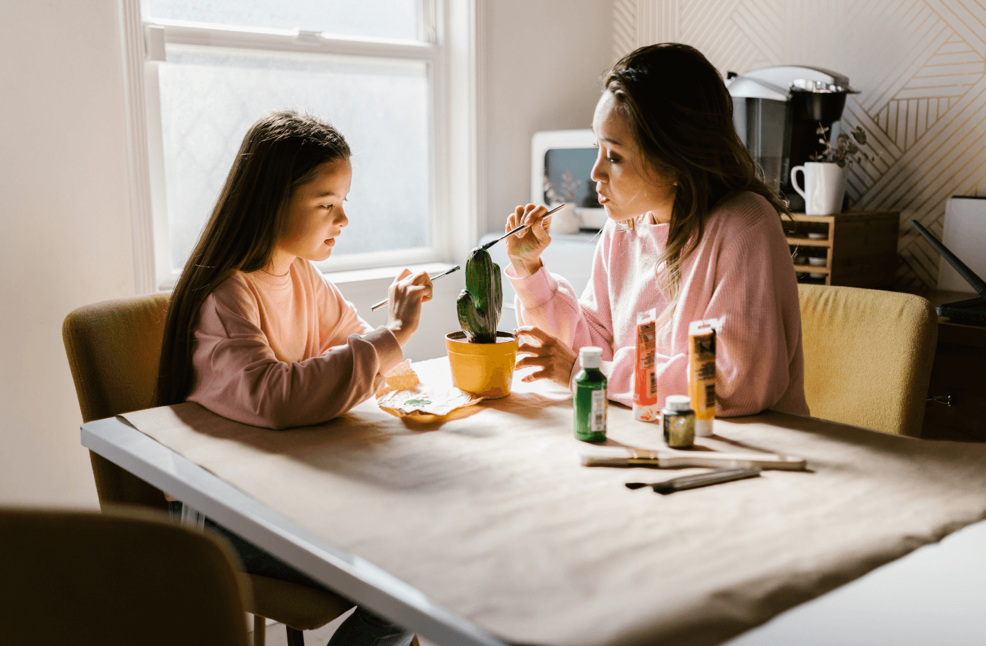 Mother and her homeschooled daughter painting together