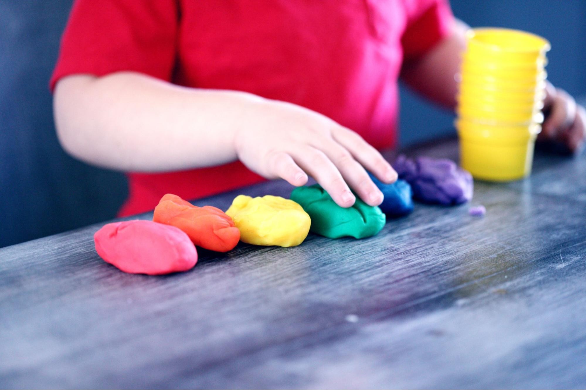 A student plays with colorful play dough.