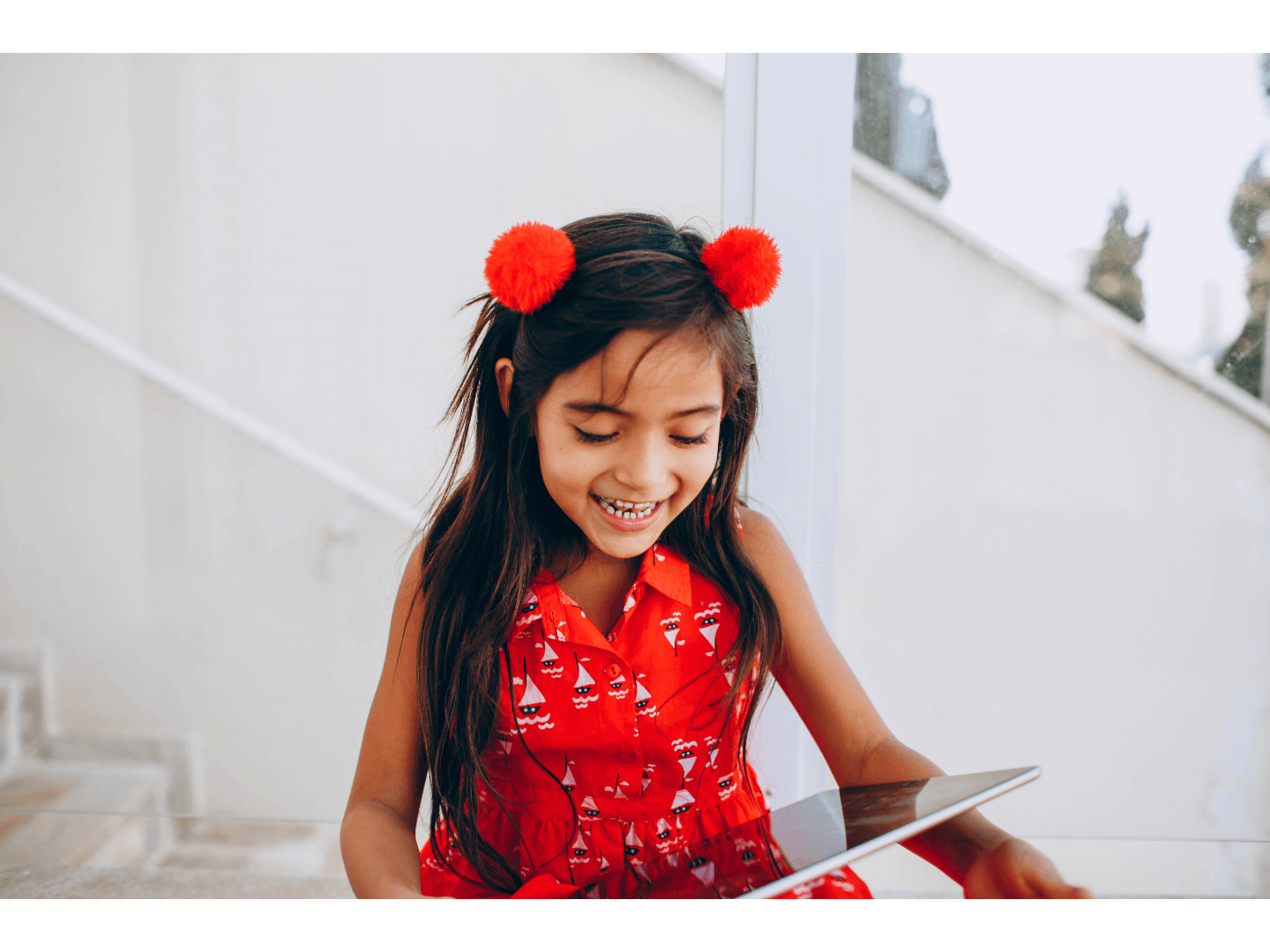 Cheerful child looking at a tablet device