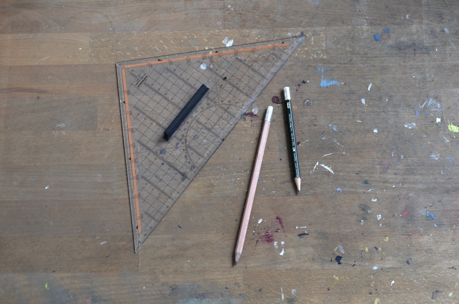 Geometry tools on a table including pencils, charcoal and a ruler.