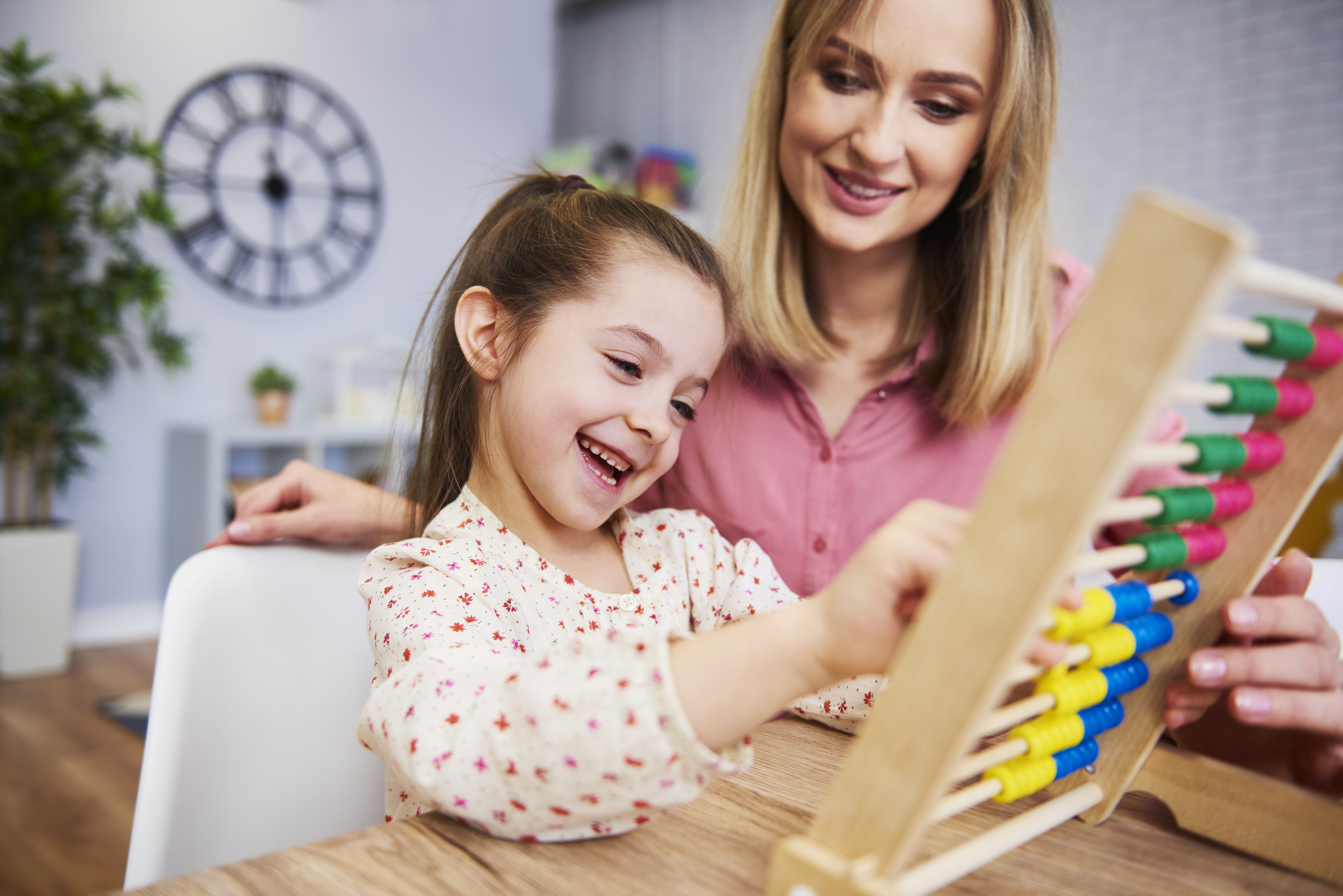 Homeschool mom with daughter using abacus.