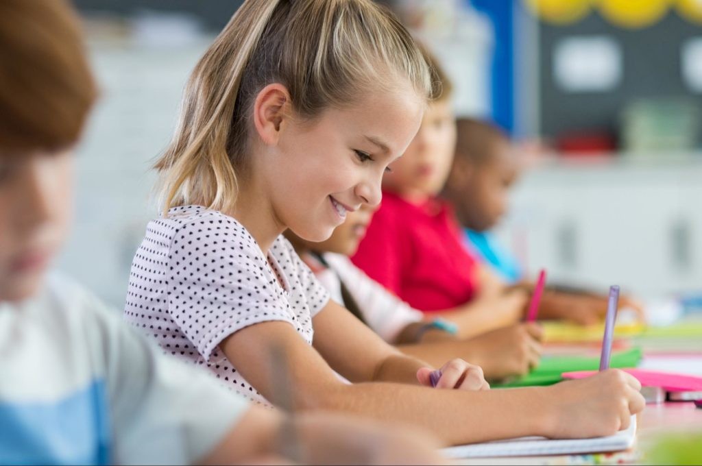 Smiling student completing an assessment