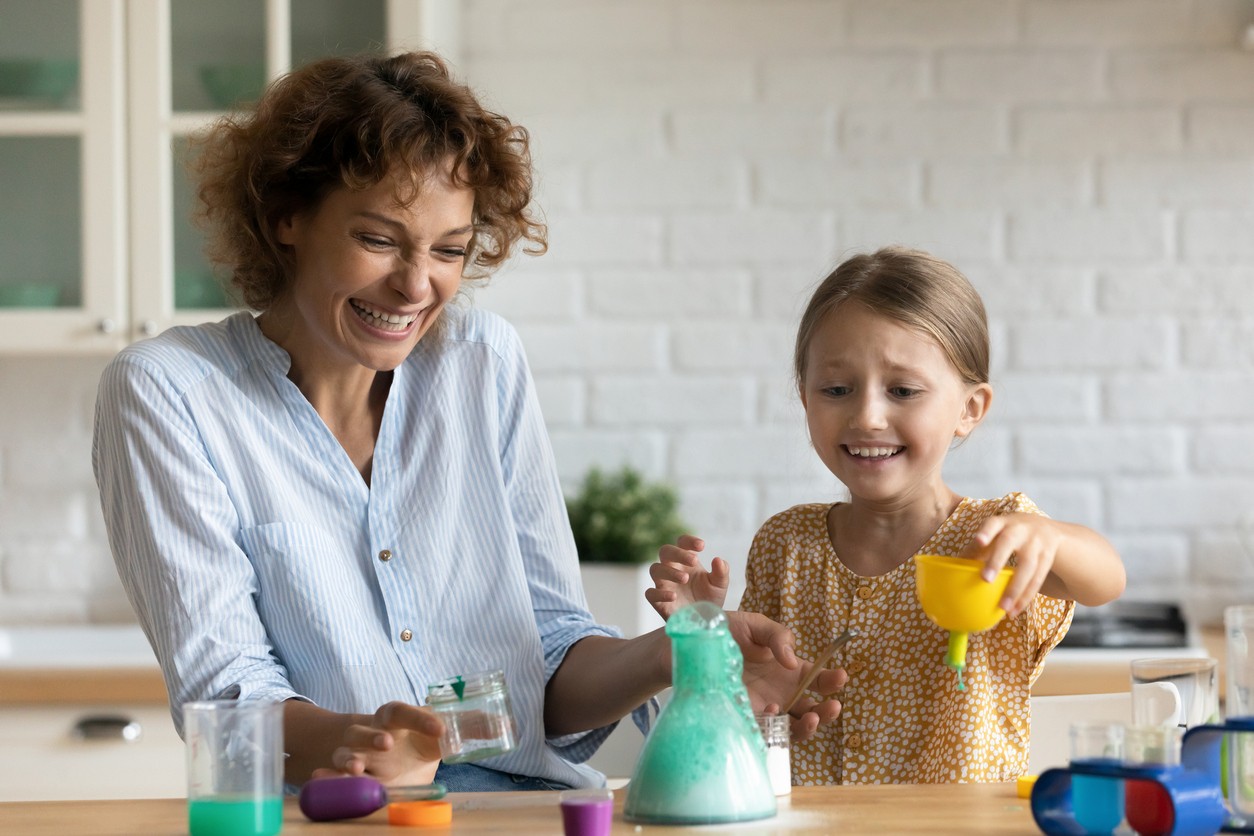 Child and her mother doing a science experiment together as part of their homeschool STEM program.