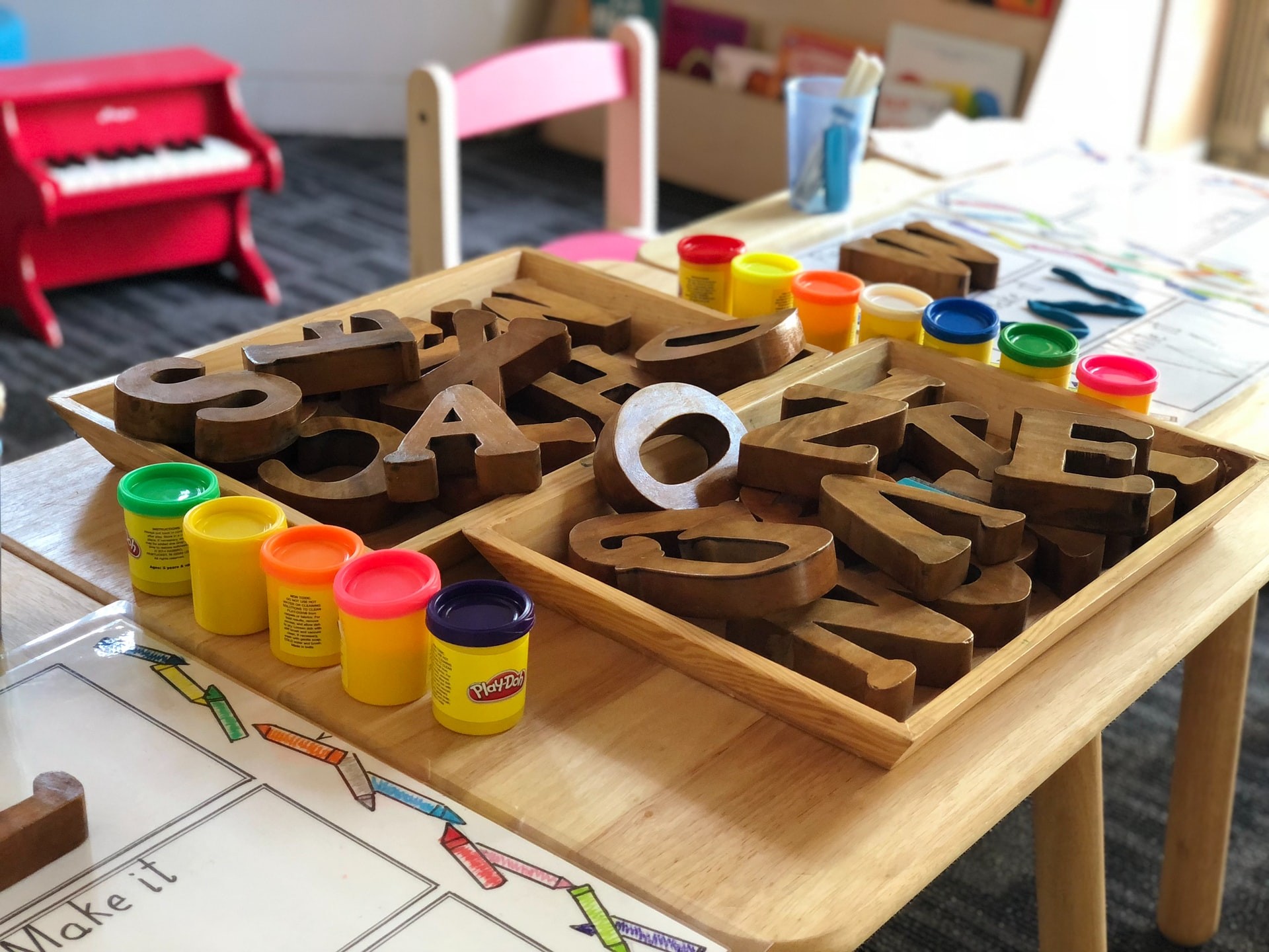 Wooden blocks and play-dough set out as part of a preschool lesson plan
