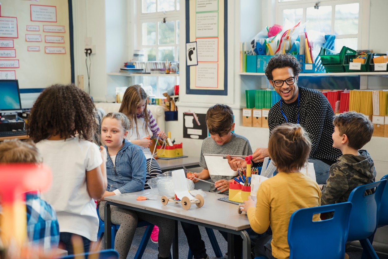 An elementary school teacher building relationships with their students in class.