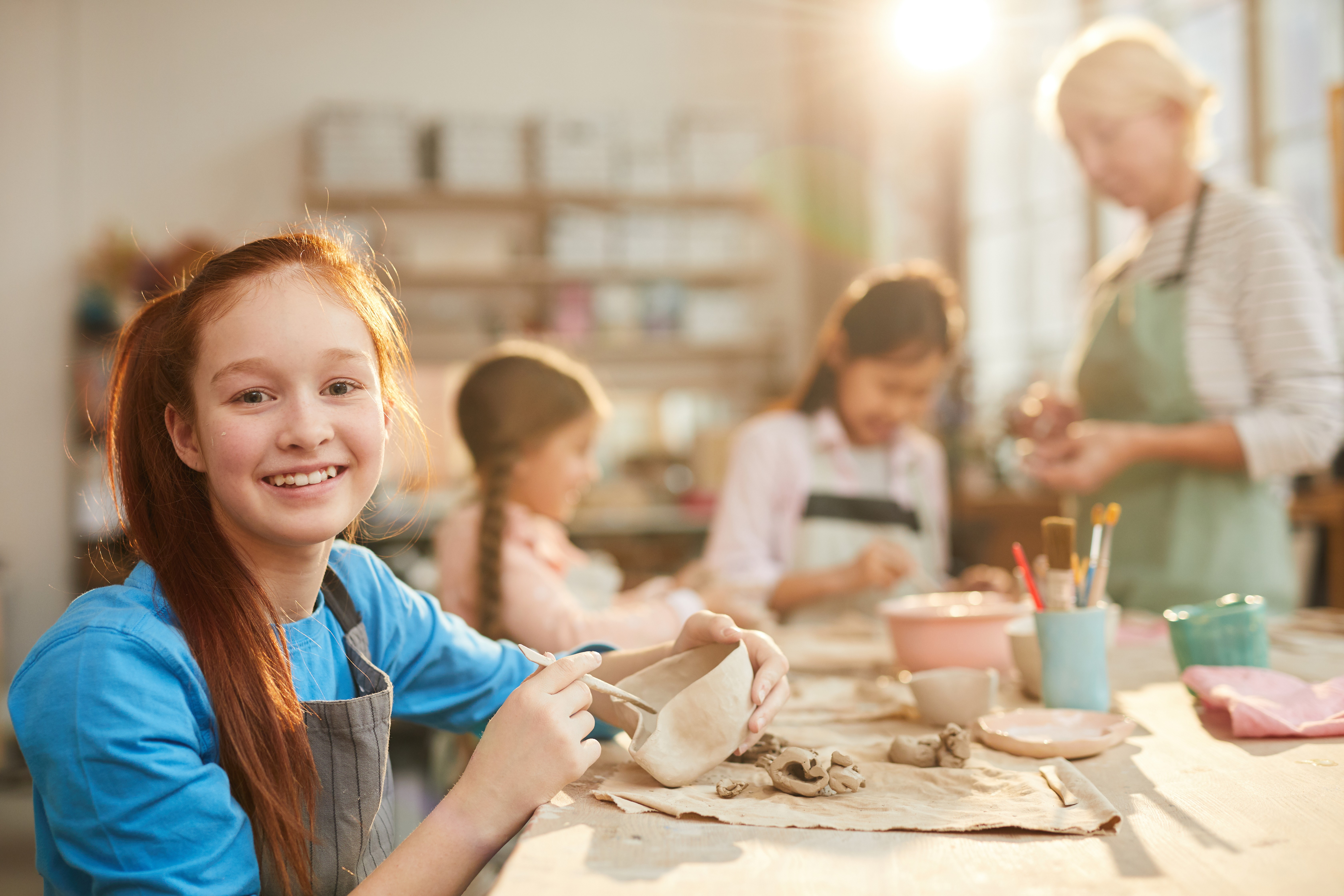 girl enjoying a pottery class