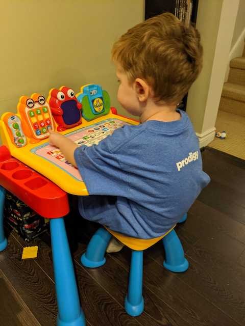 Toddler sitting at play desk