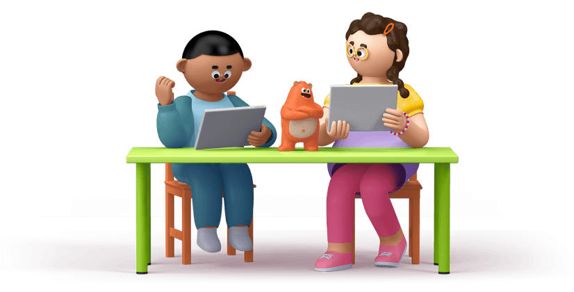 Two kids sit at a table and use tablets as Ed watches