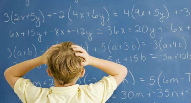 A child struggling with math on a chalkboard.