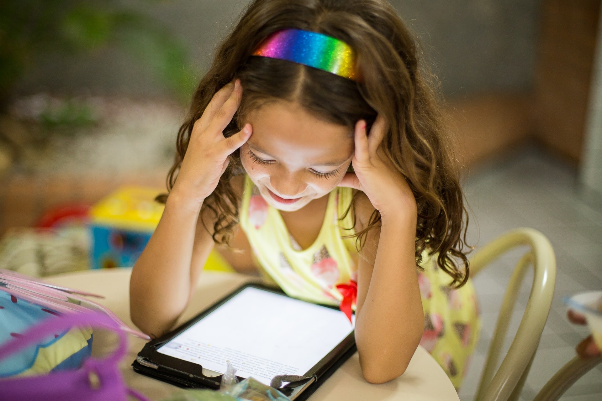 1st grade reader uses a tablet to do online learning activities.