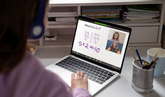 A child interacts with their Prodigy online math tutor through their laptop