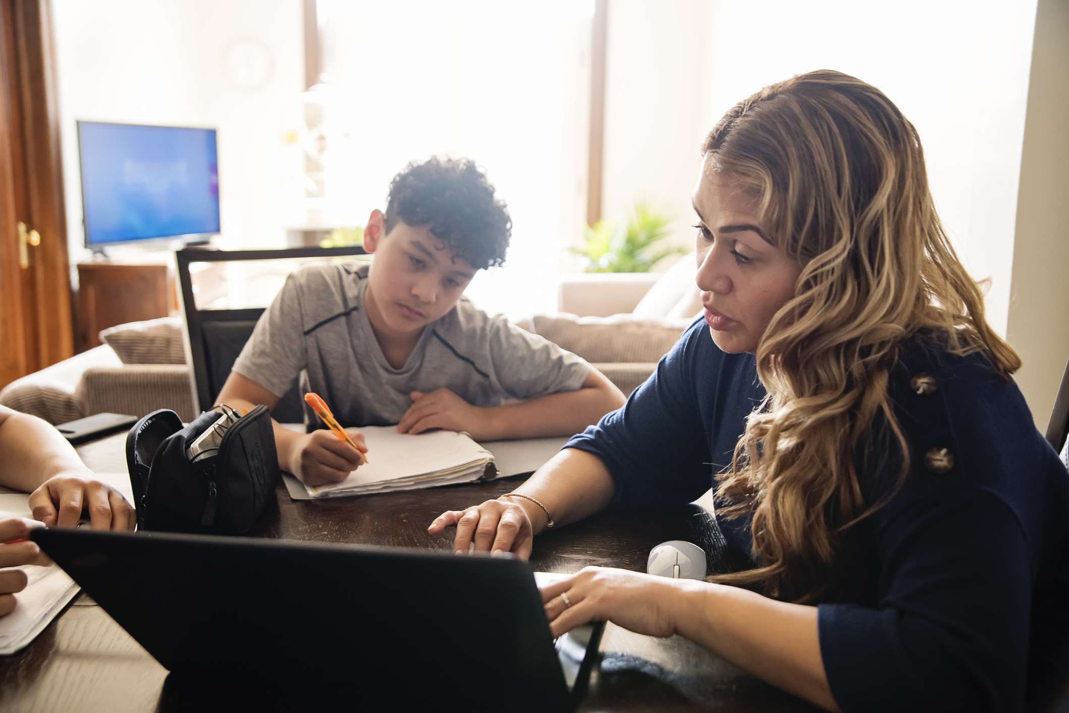 Mother homeschooling her son